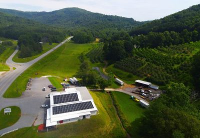 Commercial rooftop solar panels on Deal Orchards building.
